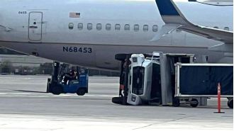 A plane collides with a truck and overturns it on the airport runway.