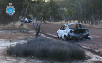 A woman is accused of murder after a man's body was discovered in a car that had been set on fire in Western Australia.