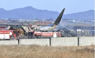 120 killed in plane crash as it veers off runway and hits fence in South Korea.