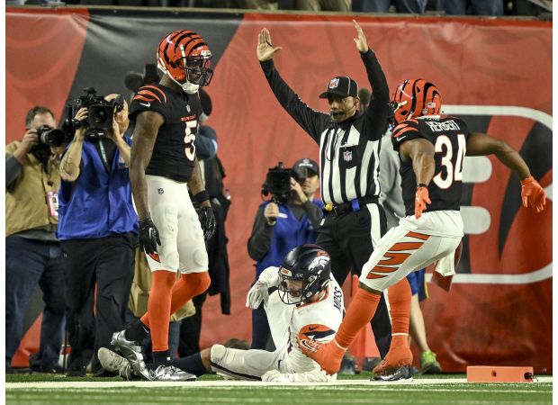 Denver's chances for the playoffs are uncertain as their coach's decision to play for overtime backfired in a 30-24 defeat against Cincinnati.