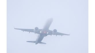 Delays at busy UK airport due to dense fog impacting hundreds of flights.