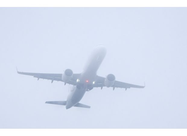 Delays at busy UK airport due to dense fog impacting hundreds of flights.