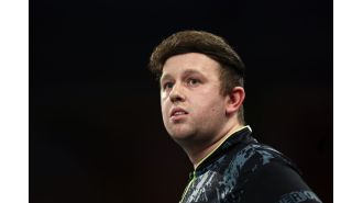 Rydz pokes fun at his hair during World Darts Championship, amusing fans.