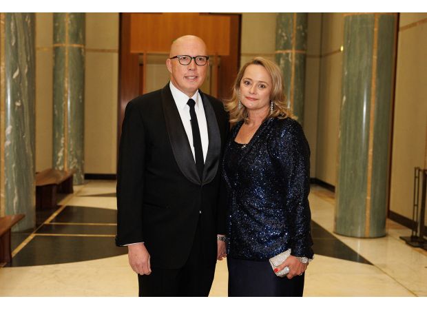 PM demands removal of offensive social media post targeting Dutton and his spouse.