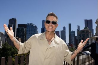 Robbie Williams makes humorous comment about aggressive menopausal women during concert.