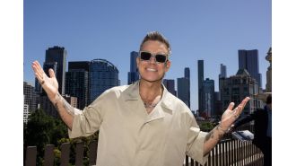 Robbie Williams makes humorous comment about aggressive menopausal women during concert.