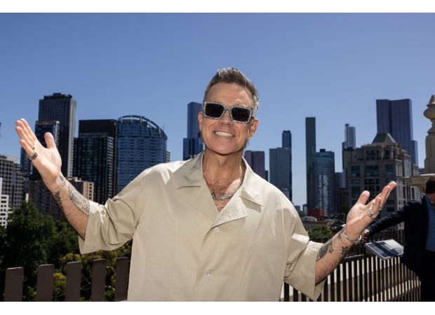 Robbie Williams makes humorous comment about aggressive menopausal women during concert.