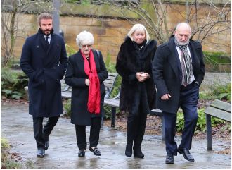 David Beckham attends funeral of Manchester United legend with a serious expression.