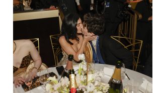 Kylie Jenner and Timotheé Chalamet share a rare public kiss amid rumors of her pregnancy.