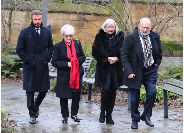 David Beckham attends funeral of Manchester United legend with a serious expression.
