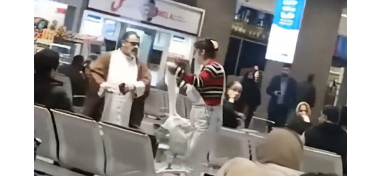Woman bravely removes mullah's turban for hijab during airport confrontation.