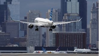 Passenger opens exit door as plane prepares to take off.