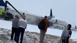 200+ passengers use slides and 4 hurt as plane aborts takeoff.