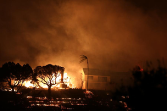 Crews battle strong winds to protect homes and landmarks as death toll increases in Los Angeles wildfires.