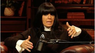 Claudia Winkleman apologises for revealing confidential details to The Traitors actor.