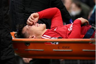 Man Utd defender Martinez taken off on stretcher with injury, causing concern.