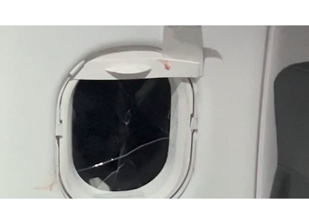 Man stopped from breaking plane window during flight.