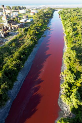 Canal's sudden red color and foul smell spark baffling investigation.