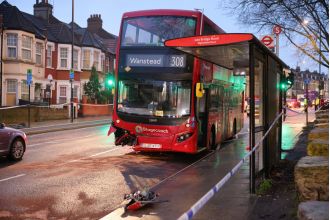 A woman died in a collision with a double decker bus in east London.