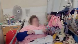 A woman was arrested and forced to leave after living in a hospital bed for 18 months.