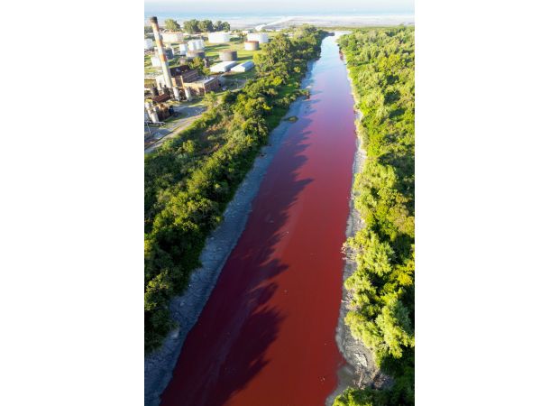 Canal's sudden red color and foul smell spark baffling investigation.