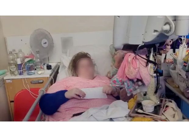 A woman was arrested and forced to leave after living in a hospital bed for 18 months.