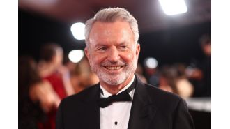 Actor Sam Neill remains positive and upbeat despite undergoing treatment for blood cancer, as seen during a recent public event.