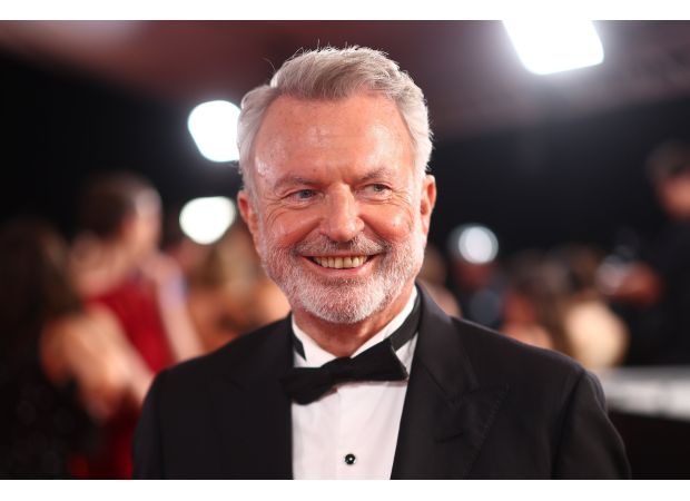 Actor Sam Neill remains positive and upbeat despite undergoing treatment for blood cancer, as seen during a recent public event.