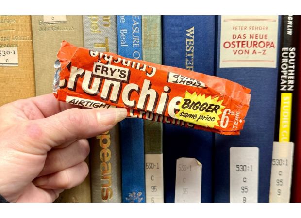 Workers discover old chocolate wrapper in strange location after 50 years.
