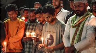Students at KIIT University march with candles to mourn the death of a Nepali student.