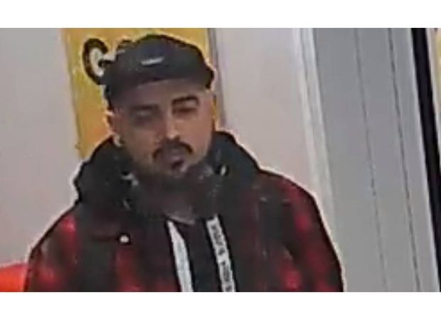 Police searching for suspect in cap and hoody after reported sexual assault at bus stop.