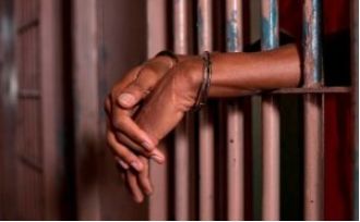A local official was arrested for forcibly removing a woman's clothes on a village road in Kendrapara.