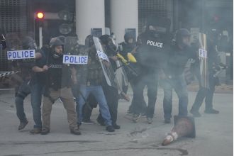 Trump's squad uses flash grenades against protestors during immigration raid.