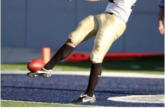 Tuskegee kicker receives backlash for kicking ball at Alabama State marching band during game.