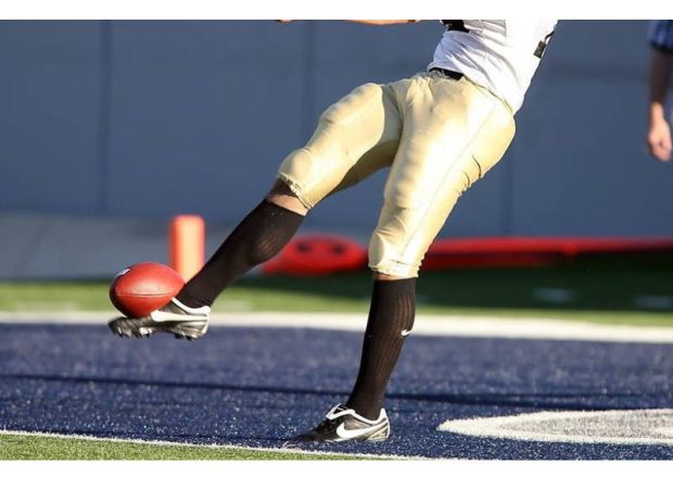 Tuskegee kicker receives backlash for kicking ball at Alabama State marching band during game.