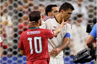 Rodri reaches out to Bernardo Silva following their encounter in the Man City legends match during the World Cup.