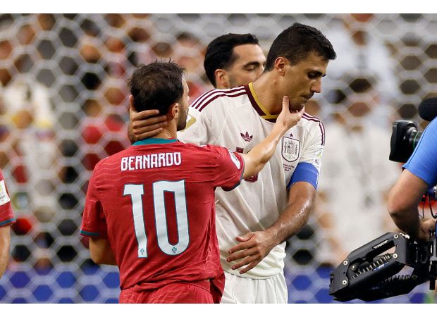 Rodri reaches out to Bernardo Silva following their encounter in the Man City legends match during the World Cup.