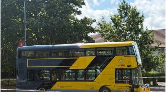Woman and two infants hospitalized following car and bus collision.
