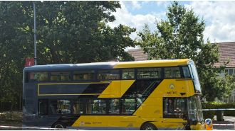 Woman and two infants hospitalized following car and bus collision.