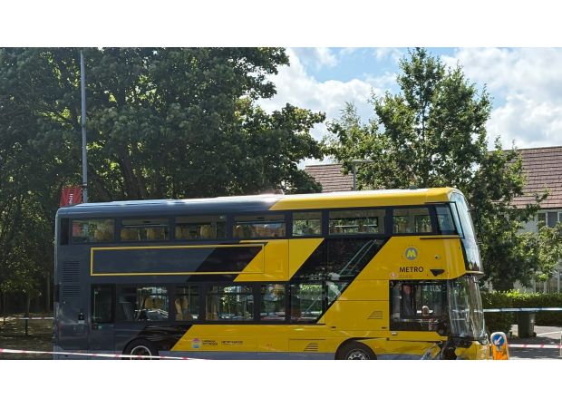 Woman and two infants hospitalized following car and bus collision.